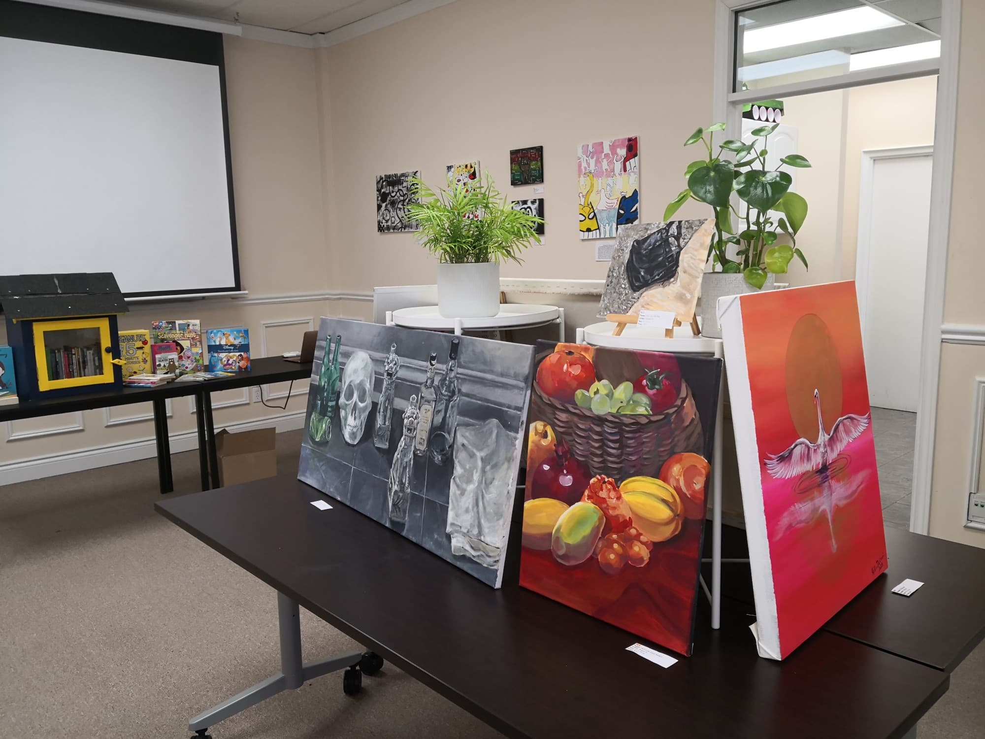 Student paintings displayed at the Elis Academy community arts auction